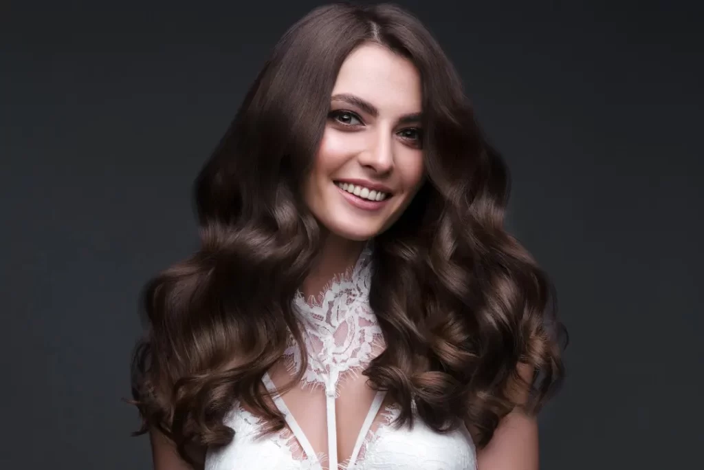 Beautiful brown-haired girl with perfectly curled hair. vitamin B12 for energy
