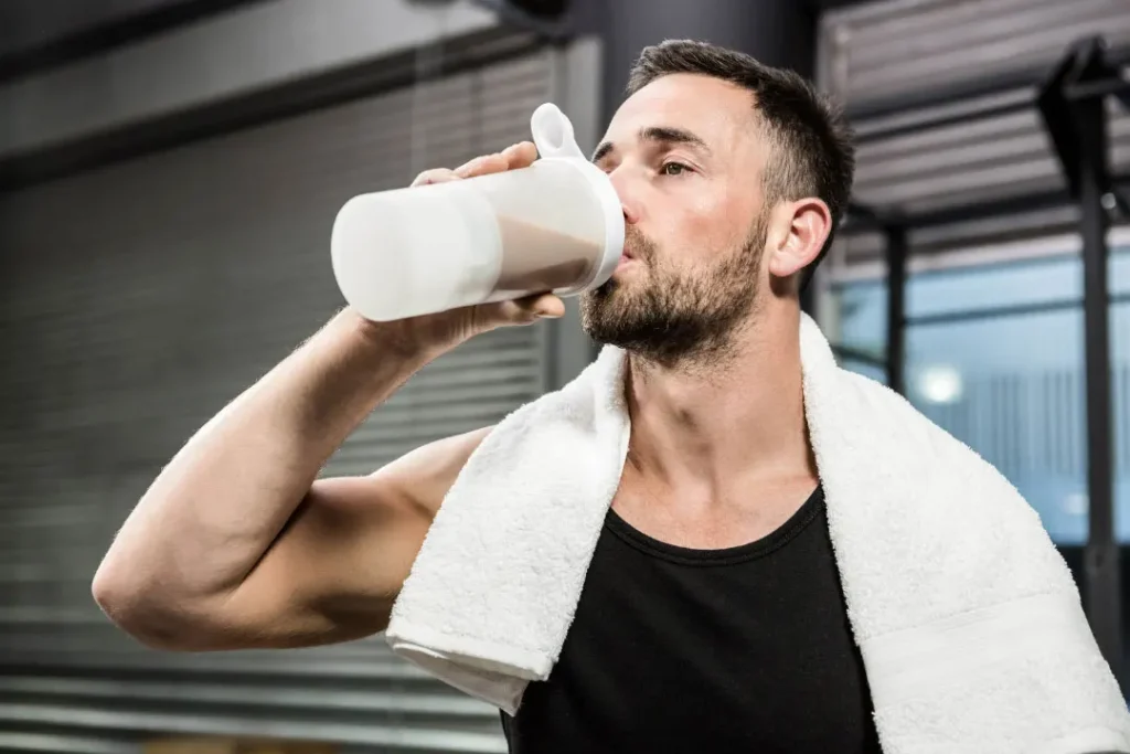 A man drinking protein shake. 