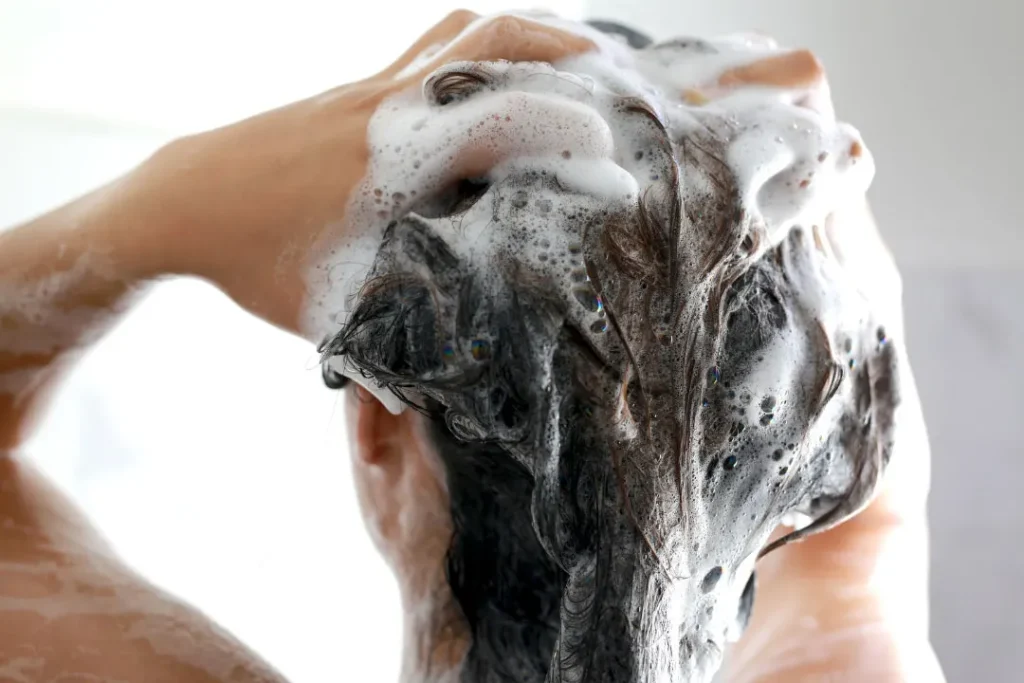 women washing hair with shampoo