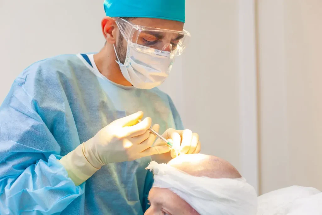 A doctor is performing the process hair transplantation.  