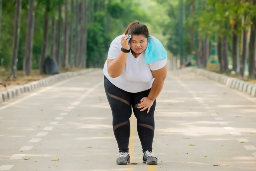 An overweight lady is tired of walking.  